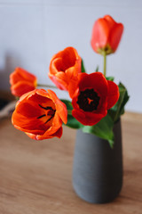 Bouquet of tulips in vase on wooden table