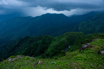 Fototapeta na wymiar Beautiful landscape with green mountains and magnificent cloudy sky Parunthumpara.Exploring Kerala,India
