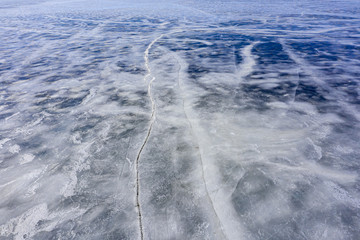 Aerial view of frozen lake. Ice from drone view. Background texture concept.