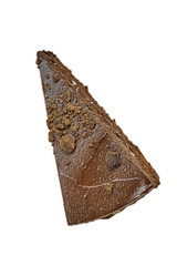A piece of chocolate cake sprinkled with pieces of chocolate. Fresh pastries, top view. Close-up, isolate