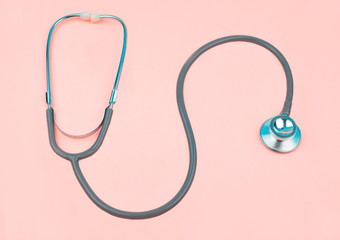 Wave form of one single normal stethoscope isolated on top of a pink color paper background