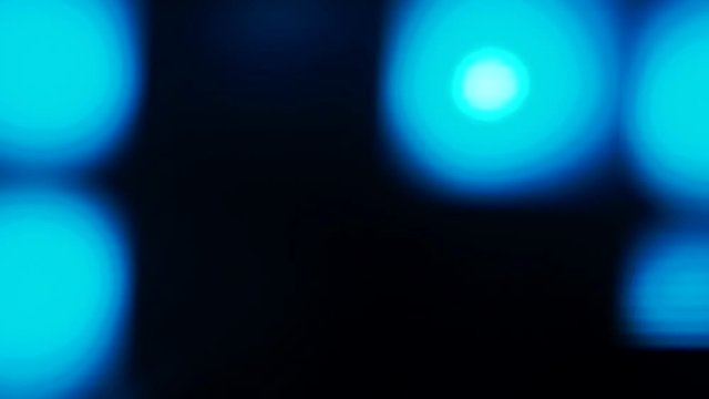 Videophone made of flashing light bulbs in blue on a black background. Lamps blink, move. The concept of textures and effects.