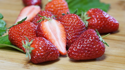 Close-up of fresh strawberries on a wooden desk