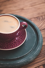 Cup of coffee with beans on wooden background, business breakfast concept, selective focus, toned vintage