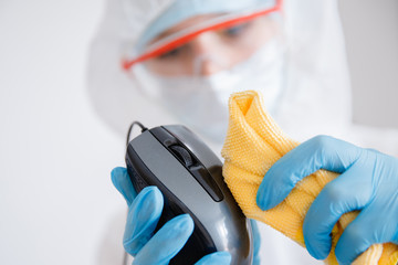 Cleaning service disinfects office Technics from coronavirus and germs, antiseptic processing computer