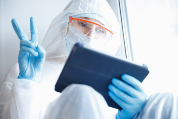Nurse woman in quarantine coronavirus clinic calls self isolation through web chat family. Online...
