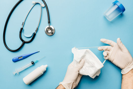 View Of A Doctor's Hands Properly Fitting Gloves And Mask With Everything Needed To Fight The Coronavirus Pandemic