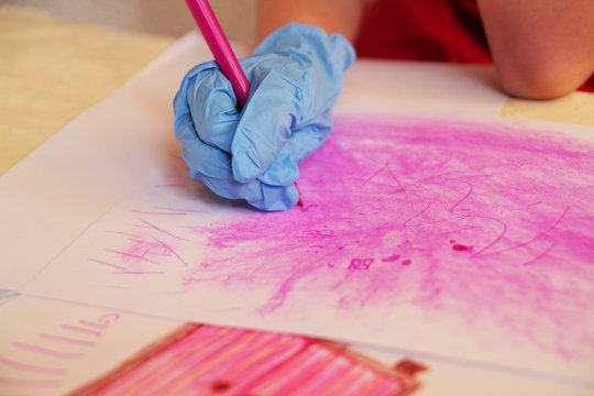 
The girl in the corontine wore disposable gloves and draws with a flamaster on paper.