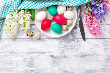 Easter eggs, pink and white hyacinth on wooden background. Easter concept. Top view. Copy space