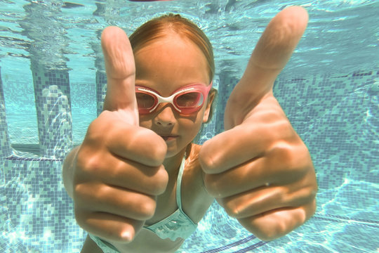 Pretty little girl in swimming pool , summer vacations.