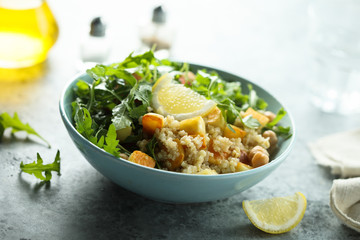 Healthy quinoa bowl with chickpea, cheese and arugula