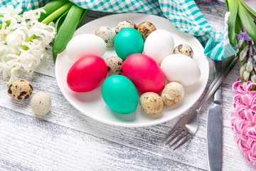 Fototapeta premium Easter eggs in white plate on wooden background. Easter concept