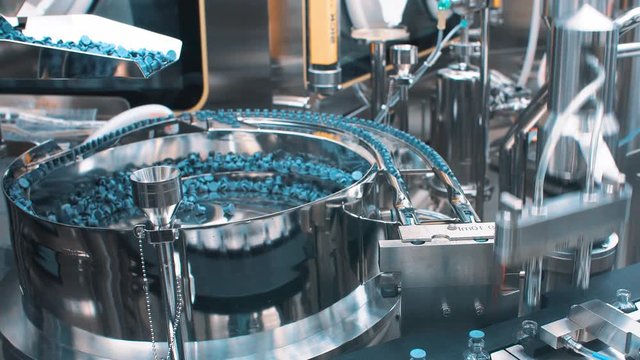 Production line for sealing caps of medical vials and ampoules after filling the medicine. coronavirus.