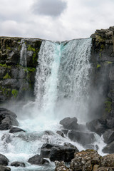 Oxararfoss waterfall in Thingvellir National park, Iceland. It flows from the river Oxara over the Almannagja.