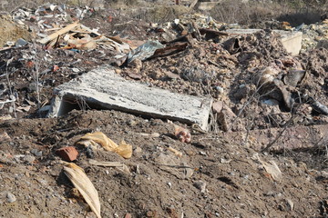 Construction waste with elements of and destroyed old structures at municipal landfill