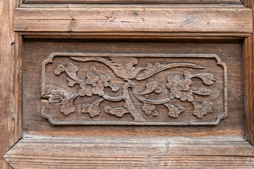 Carved patterns on wooden doors of ancient buildings in Chinese folk villages
