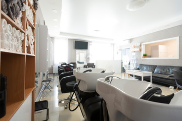 Fototapeta na wymiar Hairdressing equipment in interior of barbershop with tv
