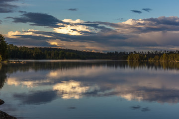 The sun setting over the lake with some interesting clouds in the sky. Sweden