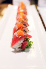 Tuna sushi with salmon row on white plate