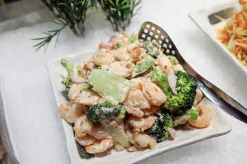 shrimp prawn salad with broccoli on ice at buffet