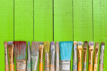 A row of artist paint brushes on desk