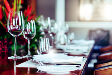 Classic setting traditional fine dining table elegant luxury style with silverware, wine glass, flower on special occasion date, family toast wedding party, anniversary, thanksgiving, christmas dinner