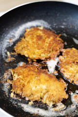 Frying grated potatoes pancakes in the frying pan