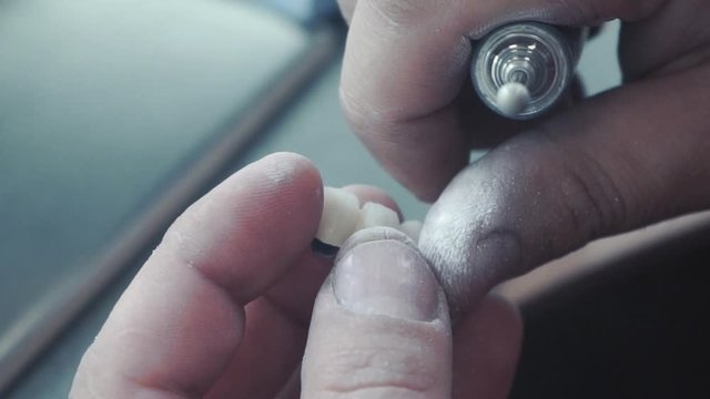 slow motion image of the dental technician who makes a prosthetic tooth