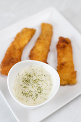 Fried chicken meat with breadcrumbs served with dill sauce