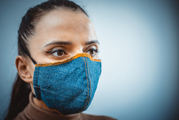 Closeup of a woman in a protective denim mask. Prevention of coronavirus and Covid -19 during a...