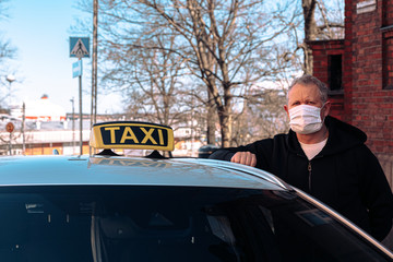Masked taxi driver
Coronavirus protection. Finnish drivers protect themselves from the virus. Taxi driver in a protective mask and gloves. Concept: Stop: Covid-19.