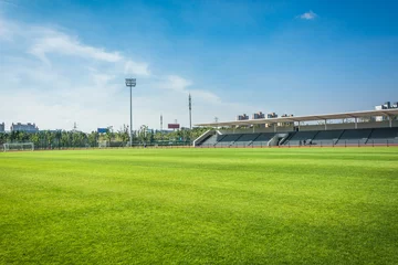 Foto op Canvas Panoramic view of soccer field stadium and stadium seats © evening_tao