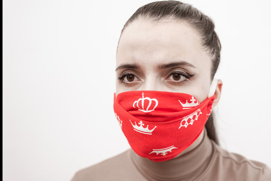 Closeup Of A Girl In A Protective Red Mask With Crowns. Prevention Of Coronavirus And Covid -19 During A Global Pandemic