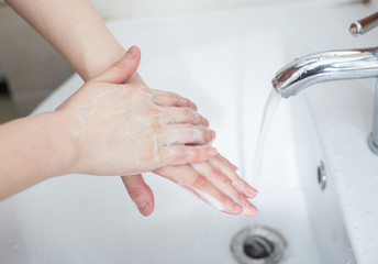 Women are washing their hands with disinfectant foam to keep the virus healthy.