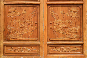 Carved patterns on wooden doors of ancient Chinese folk buildings