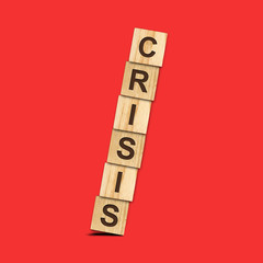 Crisis. Falling pyramid of wooden blocks on a red background. Crisis. Business. Finance.