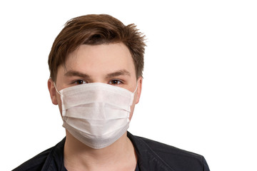 Corona virus. Young guy in a mask on a white background. Protection against viruses, infections, exhaust fumes.