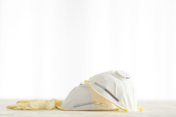 Medical masks with gloves on table
