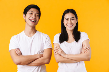 Image of multinational man and woman laughing with hands crossed