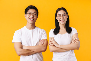 Image of multinational man and woman smiling with hands crossed