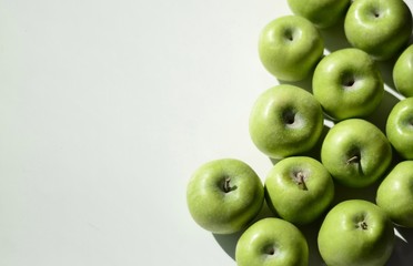  Green apples on a white background. Place for text. Fruit background. Wallpaper. Photos for recipes and menus. Background. Banner.