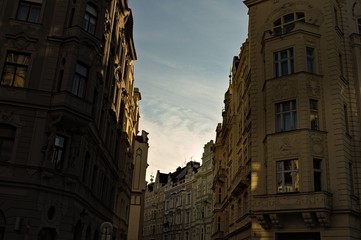 Fototapeta premium Sunset seen from a street in Prague through the buildings (Czech Republic, Europe)