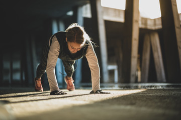 Close up of a young Caucasian woman doing push ups