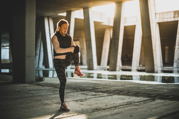 Young Caucasian woman doing legs stretching  exercises