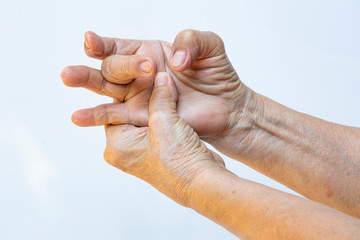 Trigger Finger lock on middle finger, Senior woman's left hand massaging her right hand Suffering from pain on white background, Close up shot, Office syndrome, Healthcare, Massage, Asian body concept