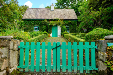 A typical Irish cottage surrounded by a green garden