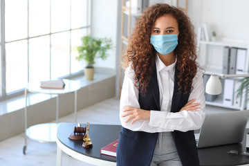 Female lawyer in protective mask working in office