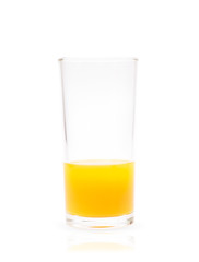 Closeup glass of fresh orange juice less than half isolated on white background with clipping path