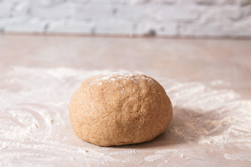 Fototapeta na wymiar kneaded dough ball from rye flour on marble countertop ready to go in oven