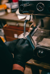 barista preparing hot milk on coffee machine
